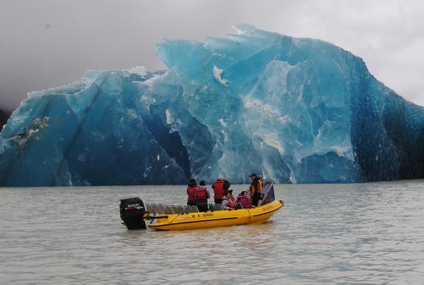 Mark Bascand from Glacier Explorers  shows astounded passengers one of the many icebergs that calved into Tasman Lake today as a result of the earthquake